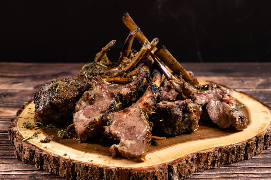 Herb-crusted Gotland lamb chops on a wooden platter
